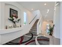 Bright and spacious entryway with modern staircase and decorative rug at 9045 Knots Estate St, Las Vegas, NV 89139