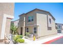 Tan two-story townhome with landscaping and fire hydrant at 9131 Hitmaker St, Las Vegas, NV 89113