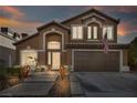 Two story house with a beautiful front yard and attached garage at 9131 Sangria Ln, Las Vegas, NV 89147