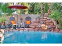 Relaxing pool area with waterfall feature and comfortable seating at 9131 Sangria Ln, Las Vegas, NV 89147