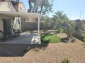 Covered patio, artificial turf, and desert landscaping in backyard at 9489 Santa Fe Rose St, Las Vegas, NV 89123