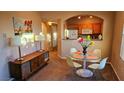 Bright dining area with glass table and four chairs, adjacent to kitchen at 9975 Peace Way # 2089, Las Vegas, NV 89147