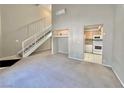 Living room with stairs, kitchen, and high ceilings at 100 S Crestline Dr # 57, Las Vegas, NV 89107