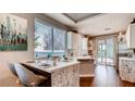 Modern kitchen with white cabinetry, stainless steel appliances, and breakfast bar at 1036 Novara Ln, Las Vegas, NV 89144