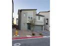 Two-story house with gray siding, gray garage door, and paved driveway at 10411 Rose Palisade St, Las Vegas, NV 89141