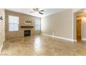 Open living room with fireplace and tile floors at 10550 W Alexander Rd # 1156, Las Vegas, NV 89129