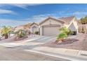 Inviting single-story home with well-manicured desert landscaping and a two-car garage at 10725 Sky Meadows Ave, Las Vegas, NV 89134