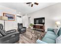 Cozy living room with modern furnishings, wood flooring, and neutral color palette at 10725 Sky Meadows Ave, Las Vegas, NV 89134