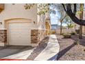 Landscaped side yard with walkway leading to garage at 1086 Sheer Paradise Ln # 101, Henderson, NV 89002