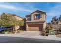 Two-story house with brown exterior, attached garage, and landscaped front yard at 1112 Via Monticano, Henderson, NV 89052