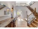 Bright and spacious foyer with elegant staircase and tile floors at 1137 Glistening Point Ave, Henderson, NV 89015