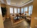 Bright living room with hardwood floors, comfy seating, and large windows at 2321 Martinique Ave, Henderson, NV 89044