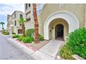 Residential building entry with arched gated entryway and landscaping at 2555 Hampton Rd # 3206, Henderson, NV 89052