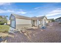 Front view of a single story house with gravel landscaping and a covered entryway at 2687 Hollowvale Ln, Henderson, NV 89052