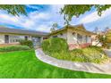 Neatly landscaped front yard with a walkway leading to the double doors at 2908 Bryant Ave, Las Vegas, NV 89102