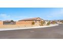 Side view of house showcasing desert landscaping and gated entry at 3614 E Routt Way, Pahrump, NV 89061