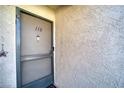 Condo's front door with screen door and number 118 at 3791 Desert Marina Dr # 118, Laughlin, NV 89029