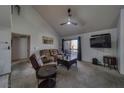 Cozy living room with high ceilings, ceiling fan, large TV and sliding glass doors at 3791 Desert Marina Dr # 118, Laughlin, NV 89029