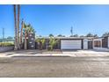 Mid-century modern home with a landscaped yard and attached garage at 3809 San Angelo Ave, Las Vegas, NV 89102