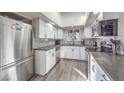 Modern kitchen with white shaker cabinets, stainless steel appliances, and gray countertops at 3809 San Angelo Ave, Las Vegas, NV 89102