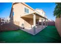 Covered patio, grassy area, and fenced backyard at 5391 Kennedy Hill Ave, Las Vegas, NV 89139