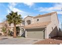 Tan stucco two-story house with a large green garage door at 5458 Walton Heath Ave, Las Vegas, NV 89142