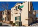 Tan two-story house with green shutters and a street view at 7453 Vital Ct, Las Vegas, NV 89149