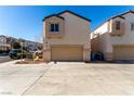 Attached garage with a tan exterior and driveway at 7453 Vital Ct, Las Vegas, NV 89149