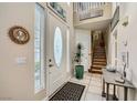 Bright entryway with tile floors, and wooden staircase at 939 Paisley St, Las Vegas, NV 89145