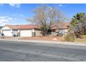 Single story home with a two car garage and landscaped yard at 1020 Blue Lantern Dr, Henderson, NV 89015