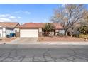 Single story home with a two car garage and landscaped yard at 1020 Blue Lantern Dr, Henderson, NV 89015