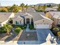 Single story home with a two-car garage and desert landscaping at 10247 Santo Nina Ct, Las Vegas, NV 89135