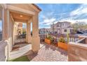 Inviting front porch with brick pavers, decorative plants, and desert landscaping at 10452 Prairie Schooner Ave, Las Vegas, NV 89129