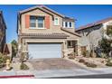 Two-story house with gray garage door, orange accents, and landscaped yard at 10640 Skye Scout Ave, Las Vegas, NV 89166