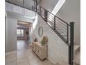 Modern staircase with metal railing and light stone wall at 10640 Skye Scout Ave, Las Vegas, NV 89166