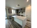 Bright kitchen featuring gray cabinets, quartz countertops, and stainless steel appliances at 1521 Bat Hawk St, Las Vegas, NV 89138