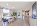 Dining room with light wood table and blue velvet chairs at 1921 Lewis Bay Ave # Lot 21, North Las Vegas, NV 89084