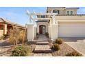 Two-story house with a pergola, brick walkway, and attached garage at 2124 Danzinger Pl, Henderson, NV 89044