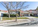 One-story house with a landscaped yard and attached garage at 2132 Timber Rose Dr, Las Vegas, NV 89134