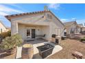 Covered patio with seating area, grill, and desert landscaping at 2255 Potter Lake Ave, Henderson, NV 89052