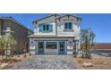 Two-story home with gray exterior, blue shutters, and a paved driveway at 2641 Snapdragon Falls Ave # 106, North Las Vegas, NV 89081