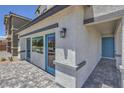 Front view of a house with blue accents and a paved walkway at 2641 Snapdragon Falls Ave # 106, North Las Vegas, NV 89081