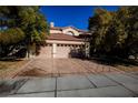 Two-story home with three-car garage and landscaped yard at 272 Arbour Garden Ave, Las Vegas, NV 89148