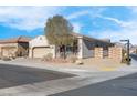 Single story house with a two car garage and desert landscaping at 320 Via Del Duomo, Henderson, NV 89011