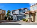 Charming two-story home with desert landscaping, a gray color scheme, and a two-car garage at 3335 Cheltenham St, Las Vegas, NV 89129