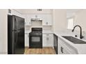 Modern kitchen featuring white cabinets and black appliances at 3400 Cabana Dr # 1108, Las Vegas, NV 89122