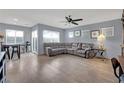 Spacious living room with gray sectional sofa and wood-look floors at 4151 San Cuervo Way, Las Vegas, NV 89115