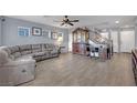 Living room with gray sectional sofa, wood floors, and built-in shelving at 4151 San Cuervo Way, Las Vegas, NV 89115