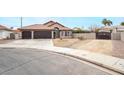 Two-car garage and front yard view of a single story home at 4417 Socrates St, North Las Vegas, NV 89031