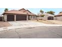 House exterior showcasing a two-car garage and landscaped yard at 4417 Socrates St, North Las Vegas, NV 89031